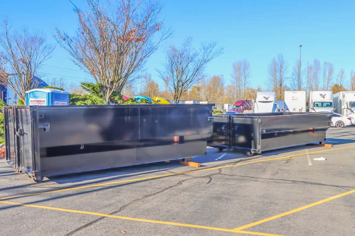 Professional dumpster rental service with roll-off container on residential driveway in Cocoa West